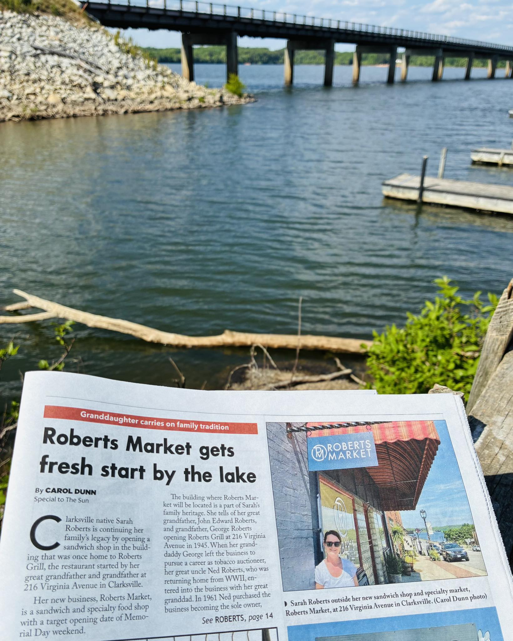 Newspaper feature on Roberts Market held up by the Clarksville waterfront