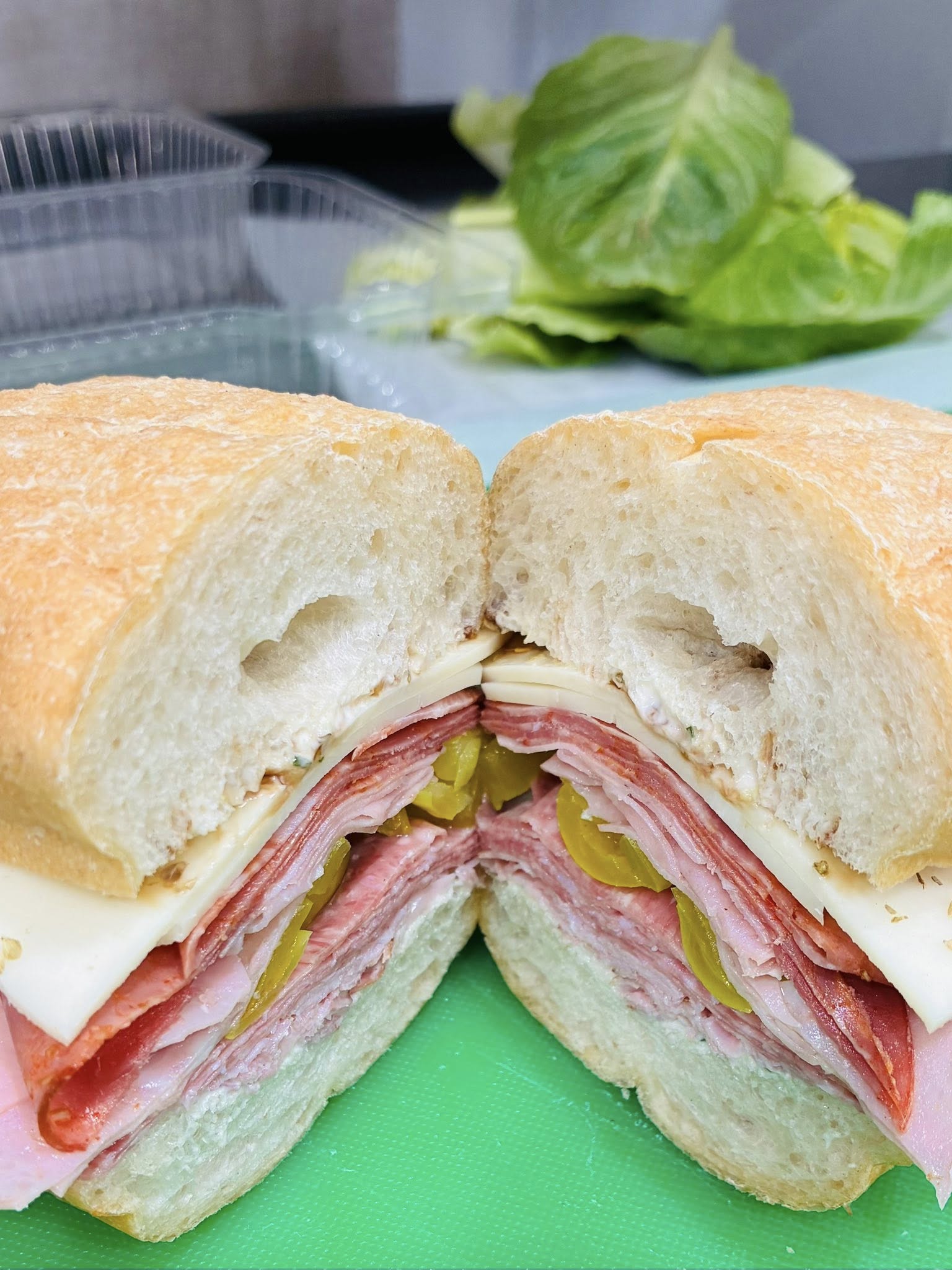 Italian sub with salami, ham, provolone and pickles on fresh house bread
