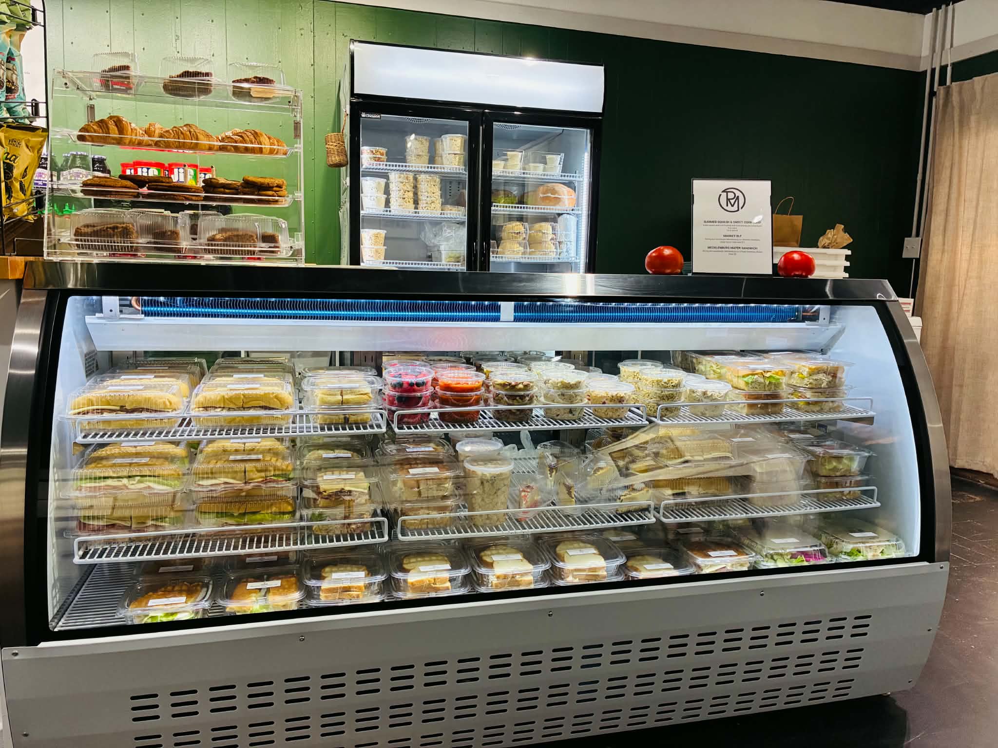 Roberts Market deli case filled with fresh made sandwiches, salads and baked goods